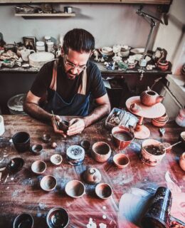 pensive-entusiastici-potter-glasses-his-own-workshop-is-workig-new-handmade-teapot-1